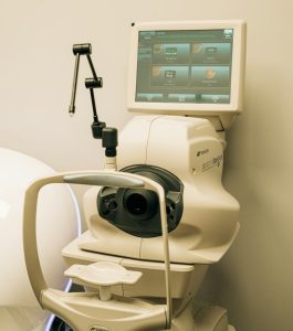 a white toilet with a monitor on top of it